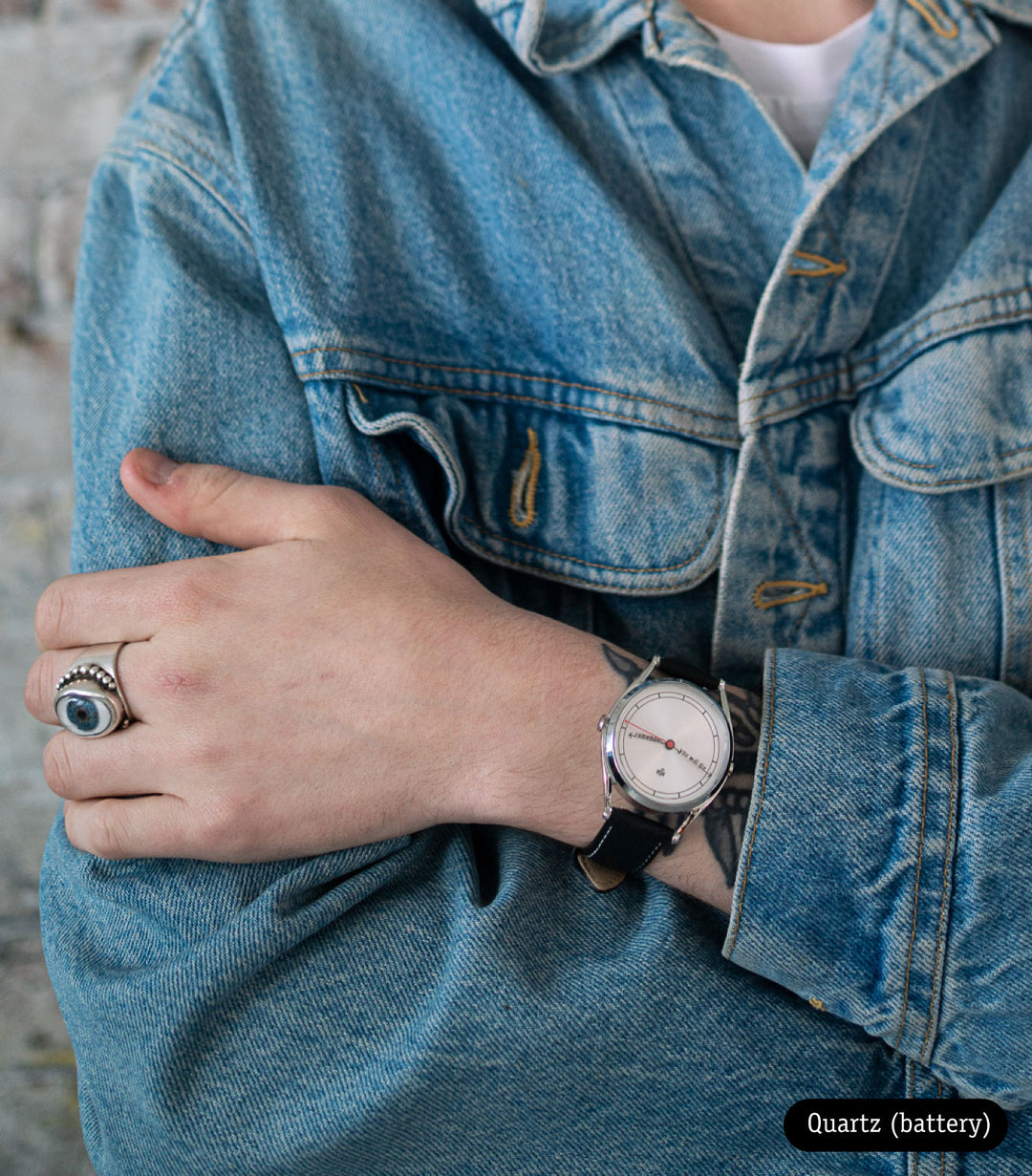 The Accurate watch worn on tattooed wrist