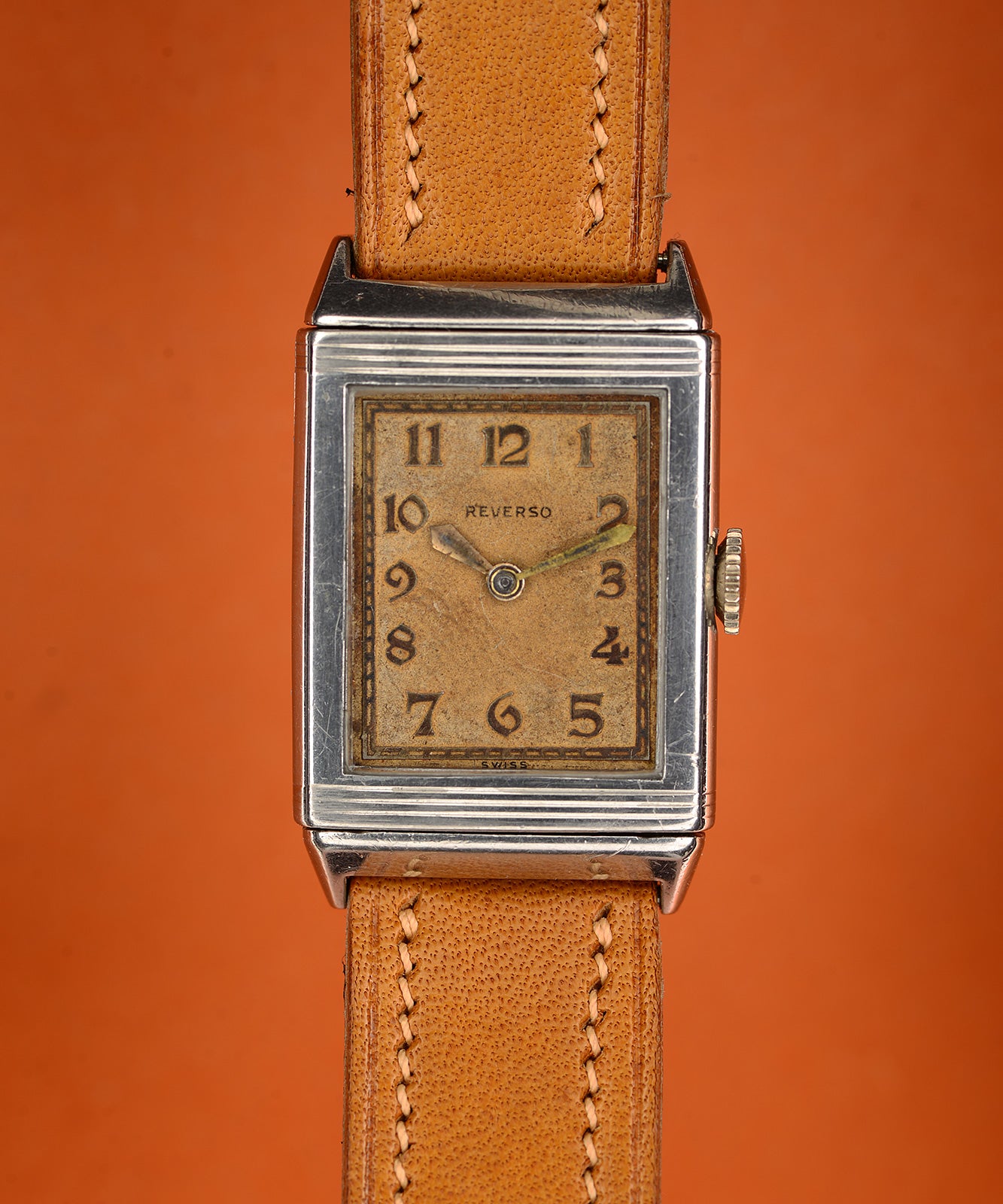 Early steel Reverso, dial side: patinated dial signed Reverso and Swiss, Arabic numerals, hour and minute hands only (no seconds hand). · Photo: Mr Jones Watches · Licence pending · Source: https://mrjoneswatches.com/products/le-coultre-reverso-c-1931