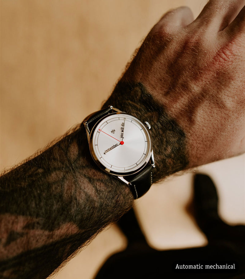 The Accurate Mechanical watch worn on tattooed wrist