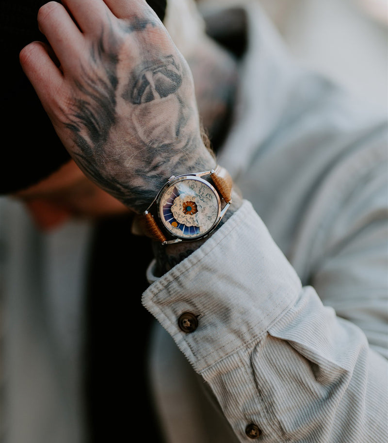 Nuage watch on tattooed wrist