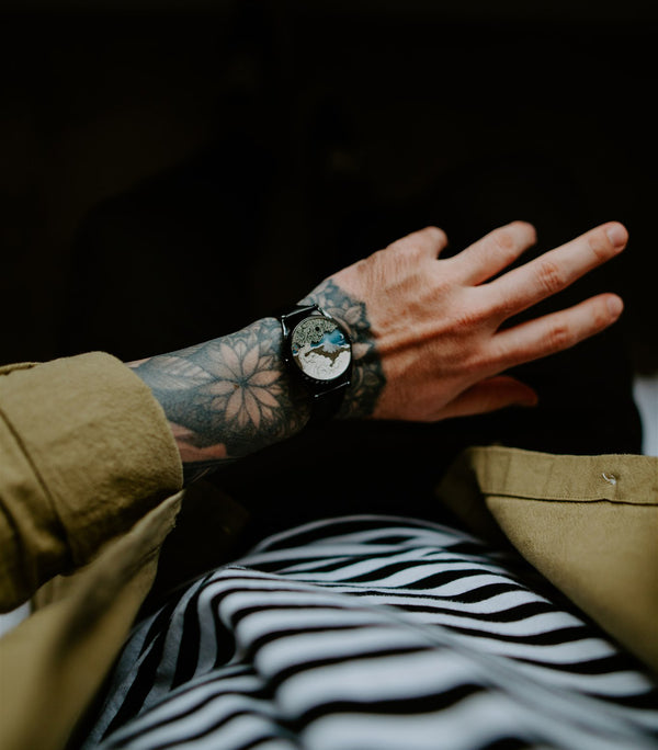The Ascendent watch worn on tattooed wrist